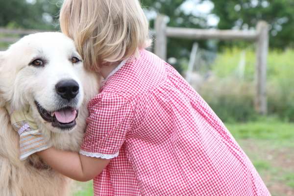 Small girl hugging the dog